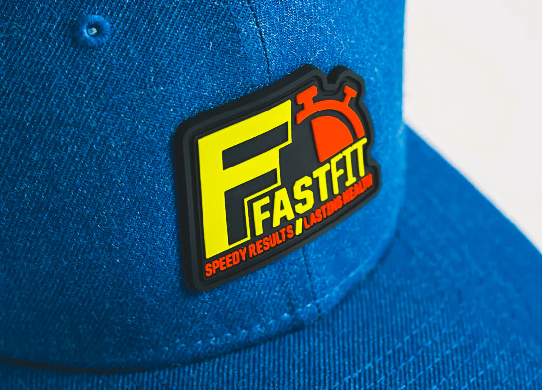 Blue hat with custom PVC patch for FastFit featuring bold yellow, red, and black design, made in Winnipeg Manitoba Canada by Rogue Lab