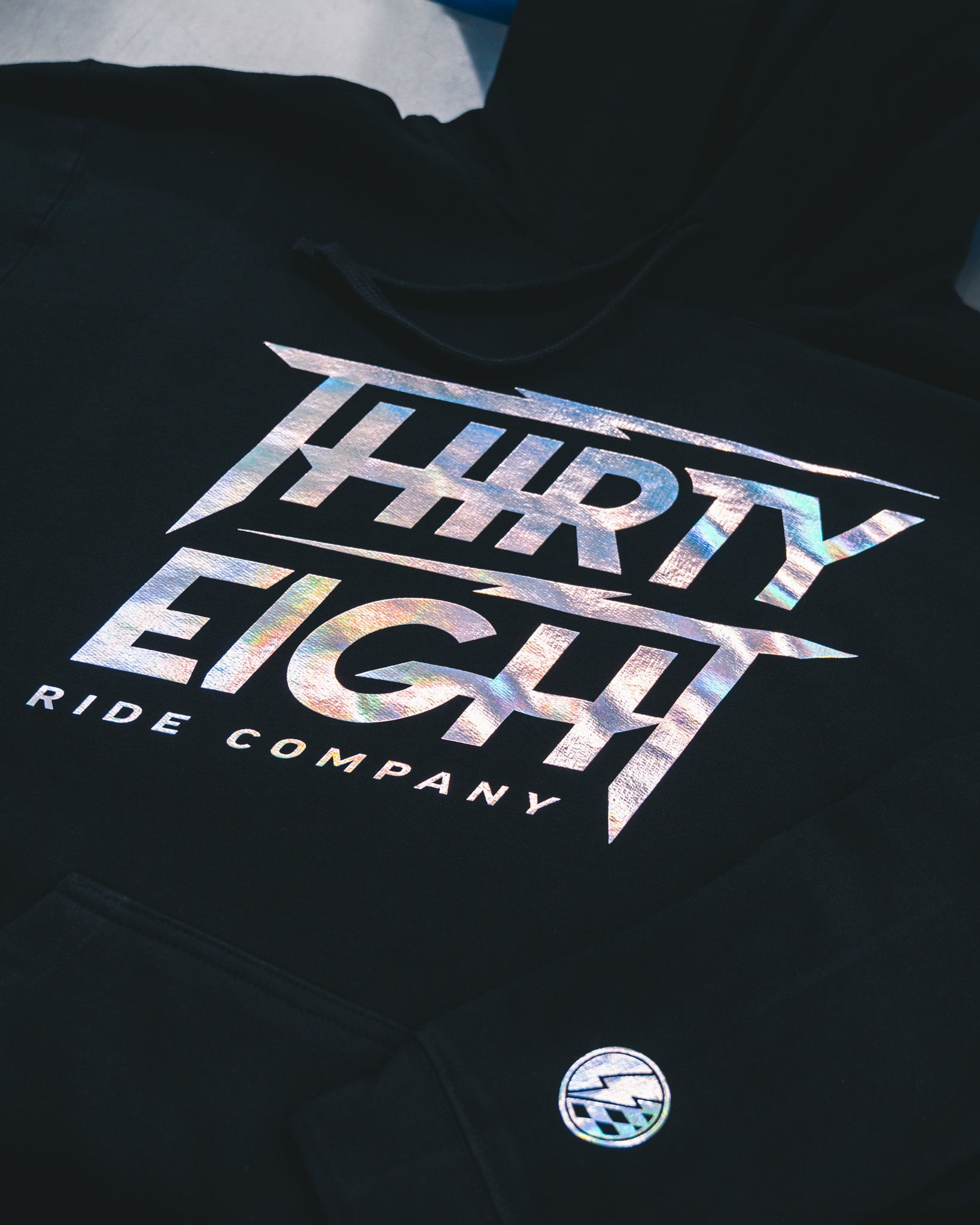 Black hoodie with custom reflective foil print for Thirty Eight Ride Company, produced in Winnipeg Manitoba Canada by Rogue Lab
