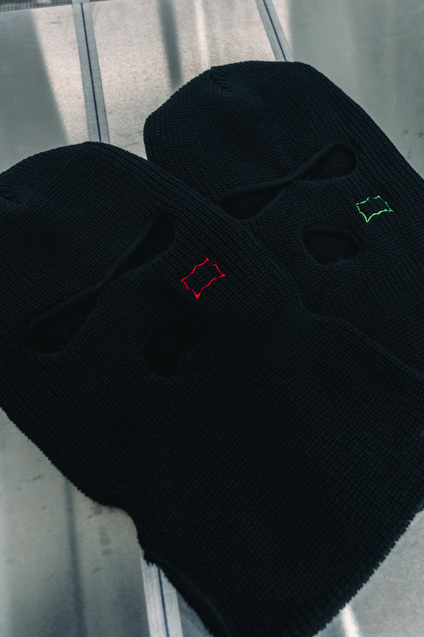 Custom embroidered black knit balaclavas with red and green stitching by Rogue Lab in Winnipeg, Manitoba