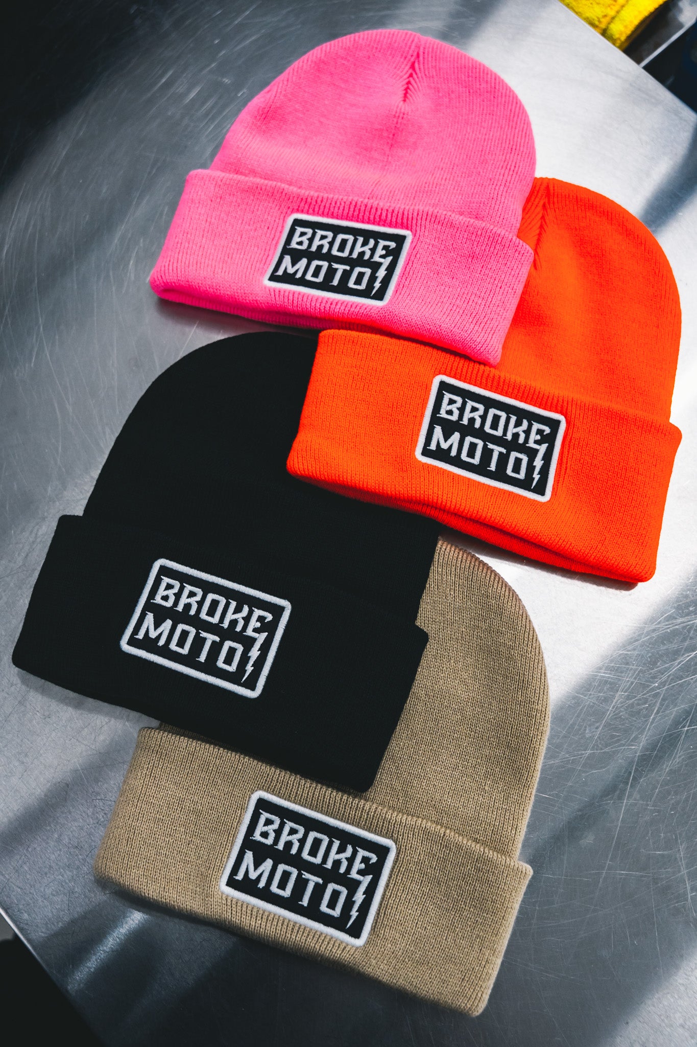 Custom embroidered Broke Moto beanies in pink, orange, black, and tan by Rogue Lab in Winnipeg, Manitoba