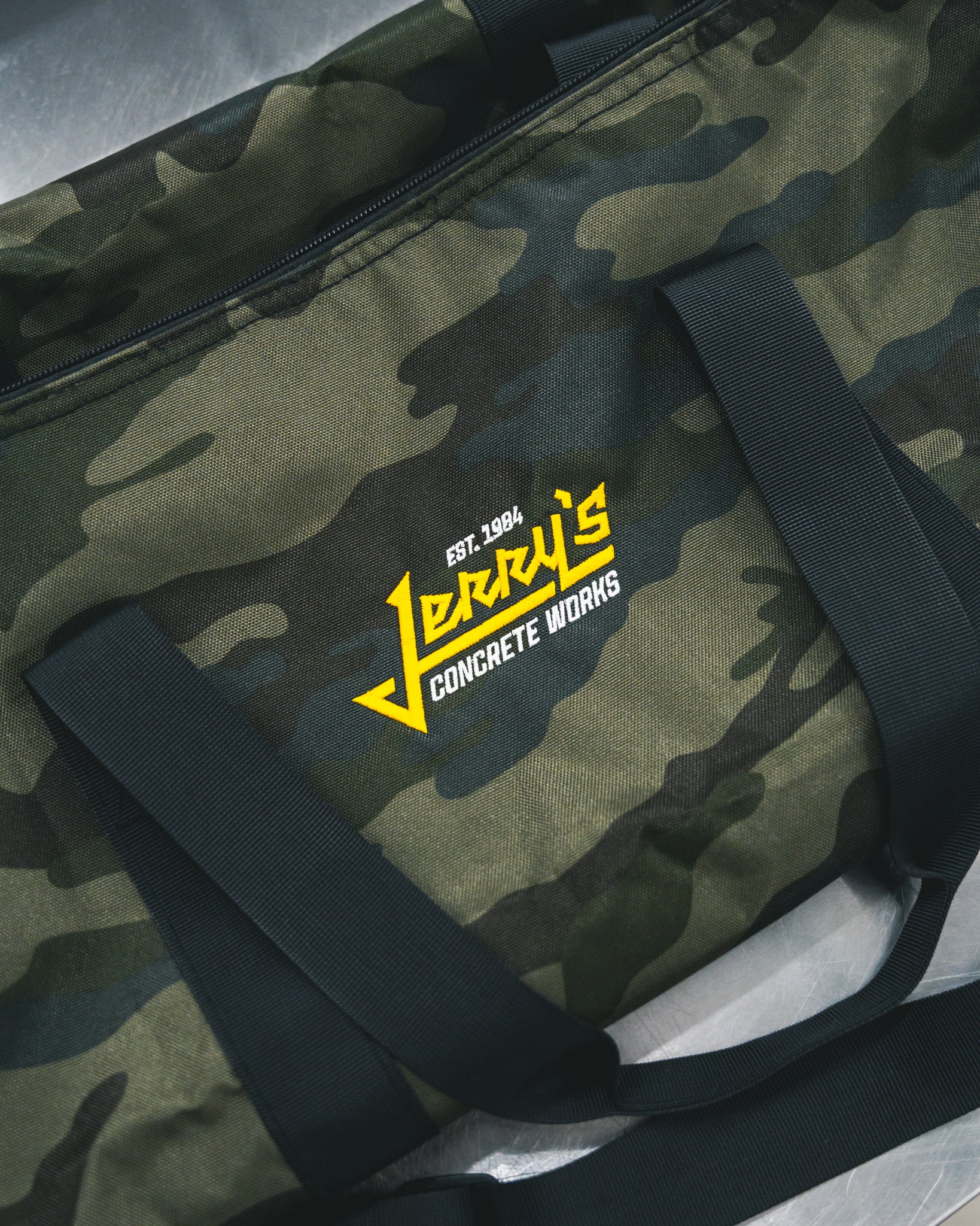 Custom embroidered camo duffel bag with Jerry’s Concrete Works logo by Rogue Lab in Winnipeg, Manitoba
