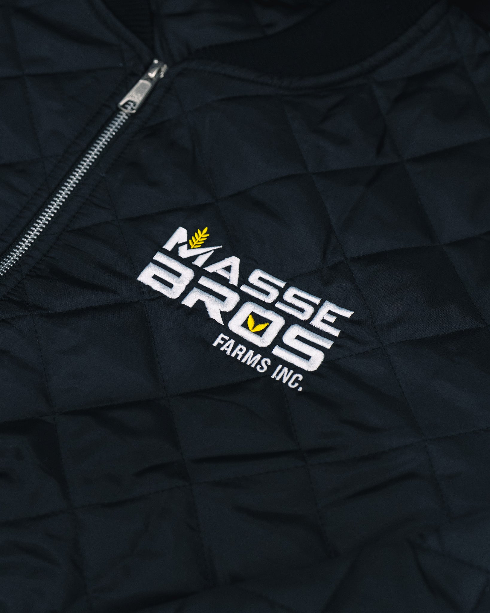 Custom embroidered black freezer jacket with Masse Bros Farms Inc. logo by Rogue Lab in Winnipeg, Manitoba